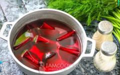 Classic recipe for hot beet soup made from young beets with tops